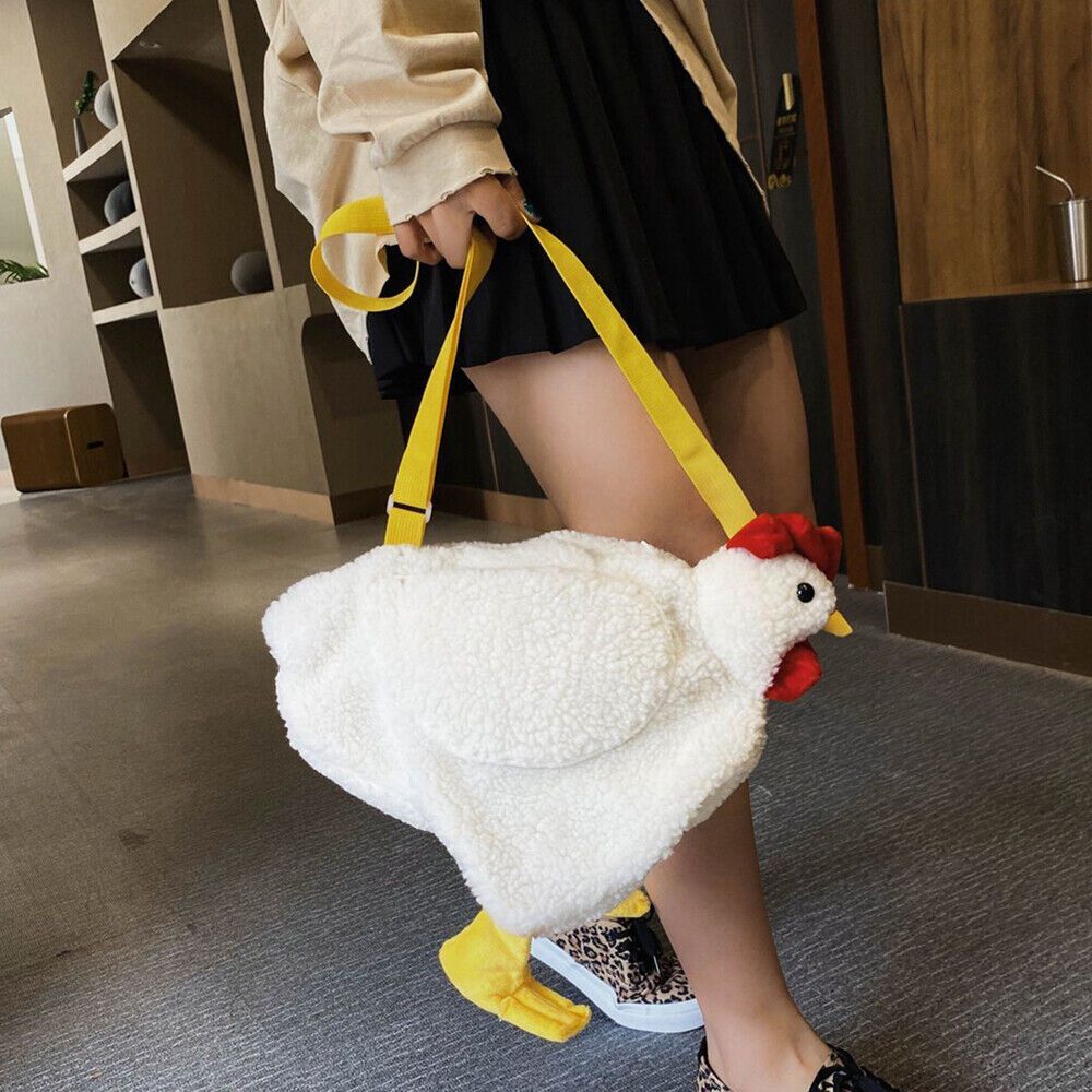 a woman is holding a white chicken bag