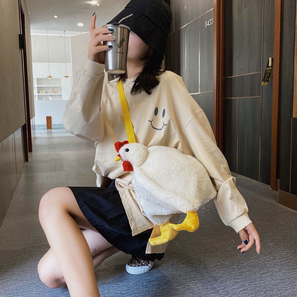 a woman sitting on the floor holding a stuffed chicken