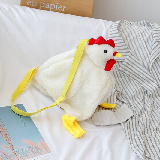 a stuffed chicken sitting on top of a bed